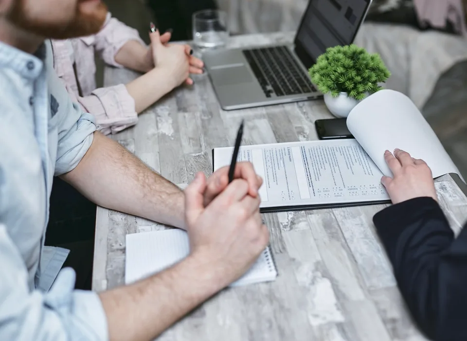 Transaction documents being reviewed at a desk
